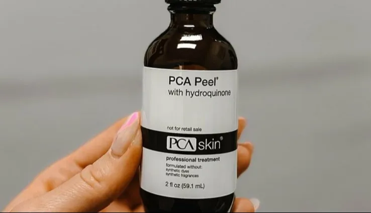 A bottle of PCA Peel with hydroquinone being held up.