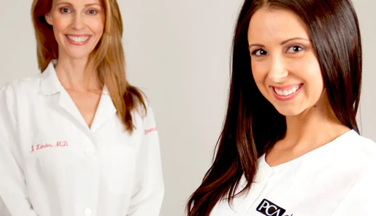 Two PCA Skin professionals smiling as they help.
