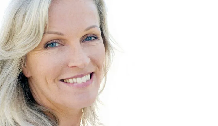 Older woman smiling in a headshot.